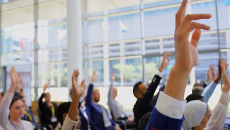 Multi-ethnic-business-people-raising-hands-in-the-business-seminar-4k