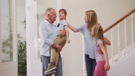 Senior-Caucasian-couple-with-grandchildren-spending-time-at-home-together