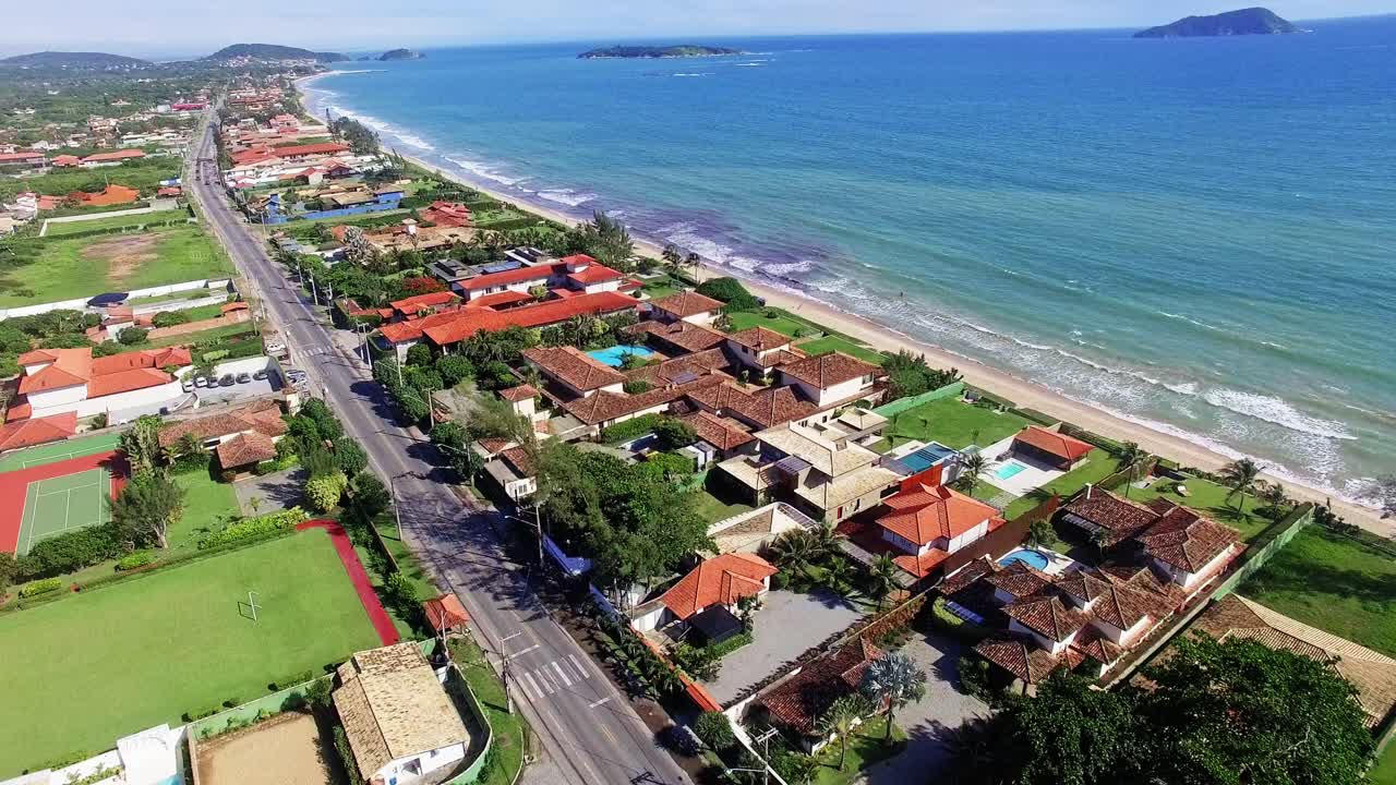 Breathtaking aerial shot of Búzios, showcasing the vibrant coastline and calm turquoise waters under a clear, sunny sky. Perfect for tourism projects.