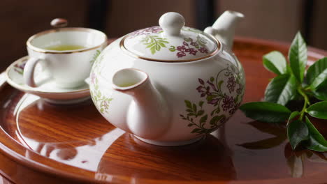 elegant tea set on wooden tray