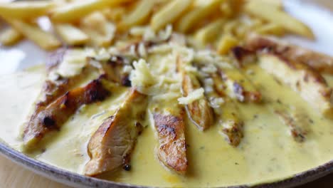 chicken strips with creamy sauce and fries