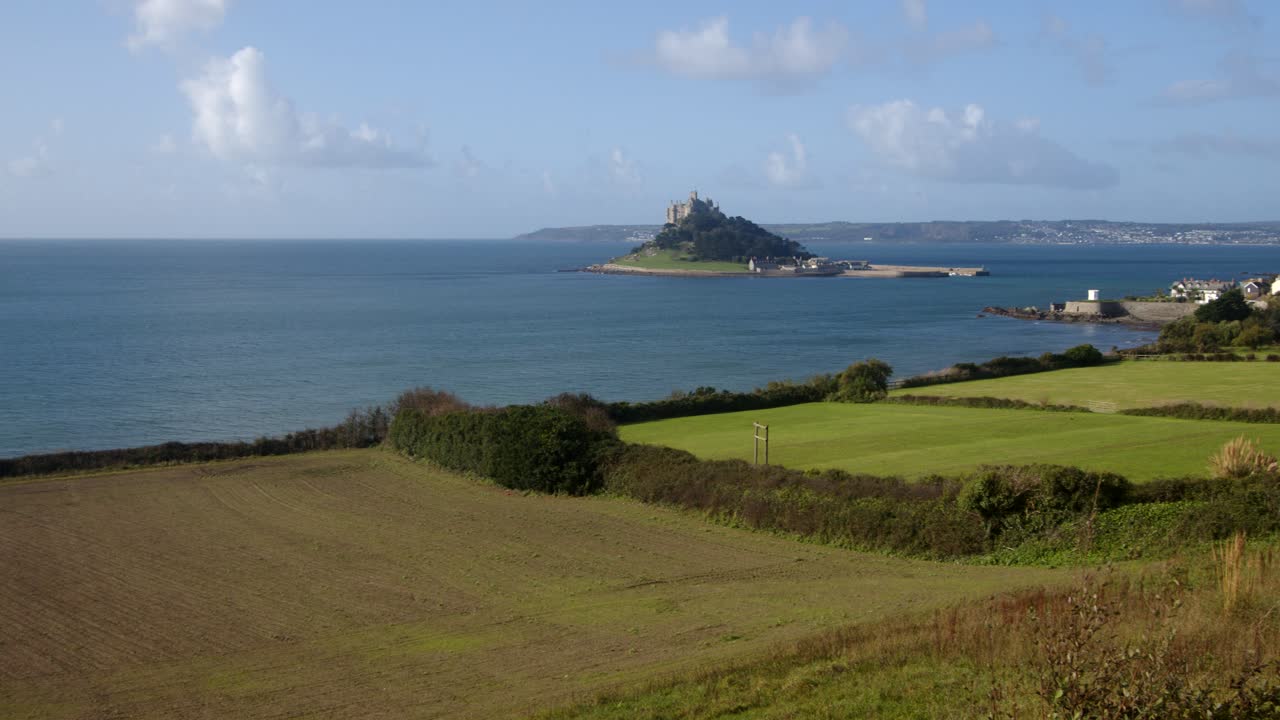 extra wide panning shot of St Michael's mount with the village of Marazion right of frame