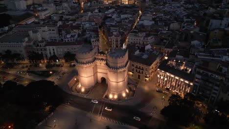 night aerial view of landmark torres of serrano and historic old city valencia, spain