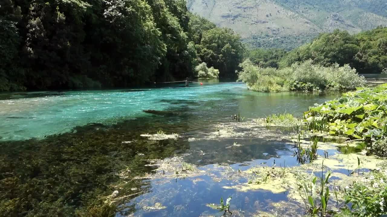 Turquoise river flows down in the Blue Eye Nature Monument near to Saranda, Albania