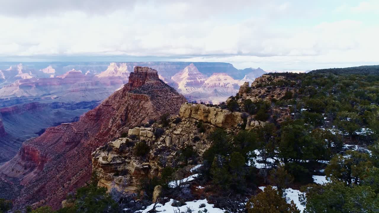 Drone of stunning Grand Canyo view of rugged cliffs, snowy, vivid terrain, 4K