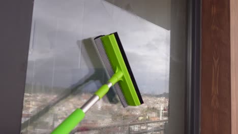 cleaning windows with squeegee