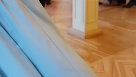 multiple dancers perform synchronized steps in indoor studio on shiny wooden floor