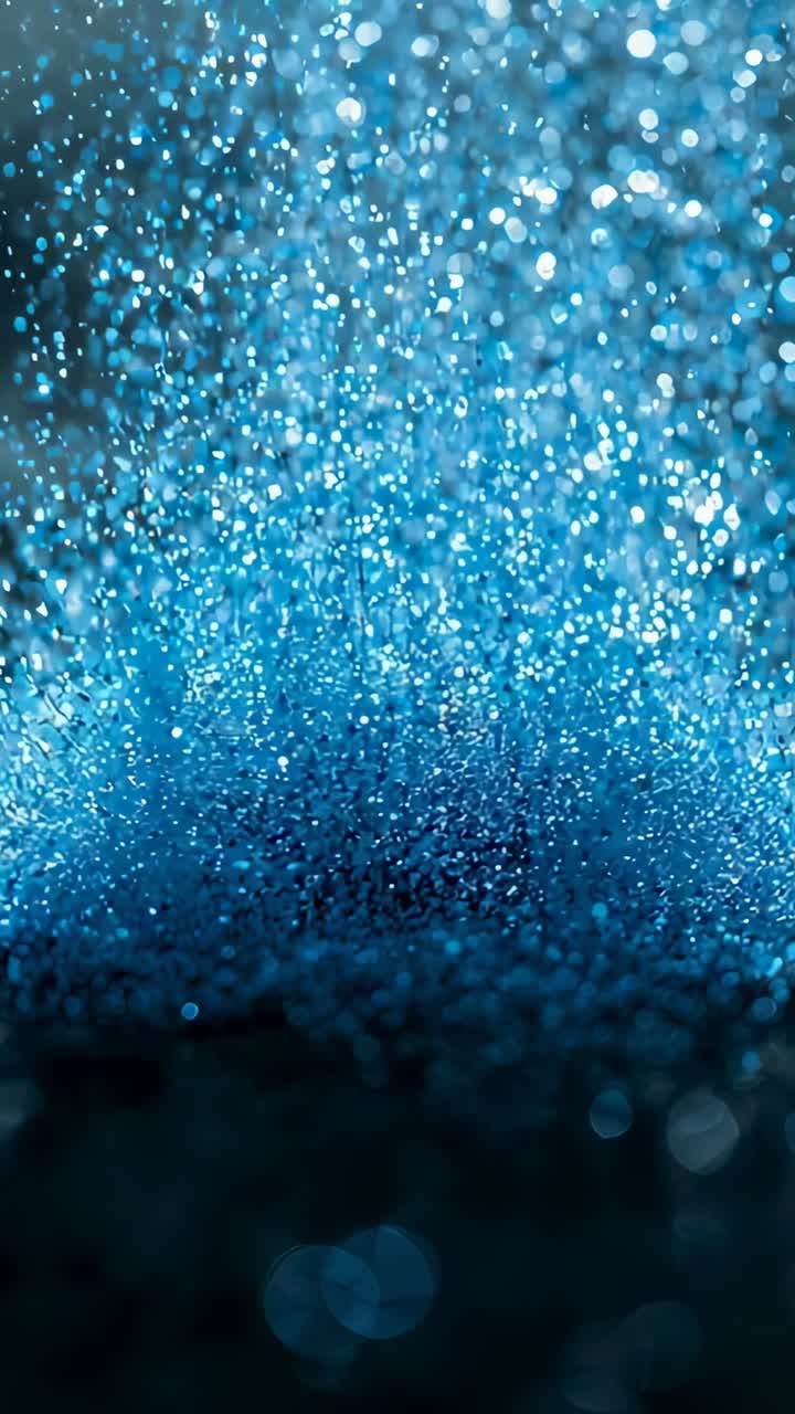 Vertical video: Pulling focus, camera revealing blue glitter on dark base, shifting into bokeh