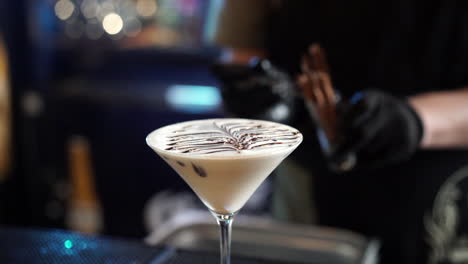 bartender topping decoration garnish cocktail with cinnamon slow motion