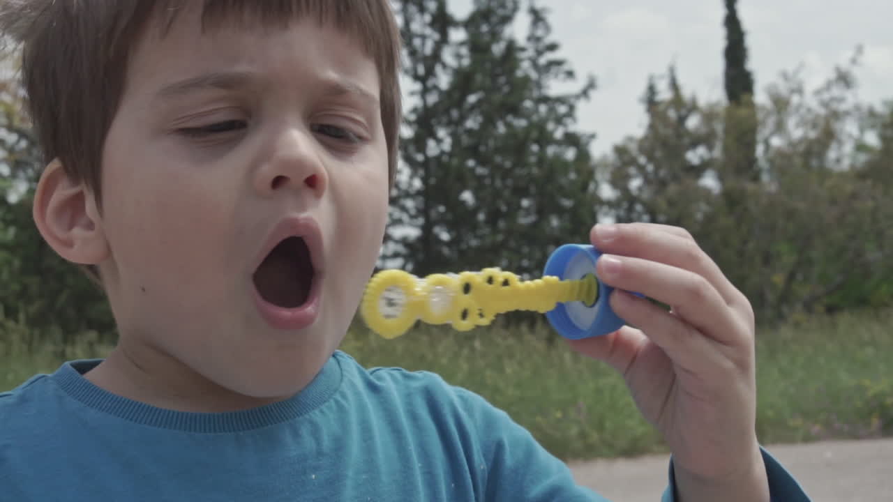 Kid Plays with a bubble blowing toy 60fps