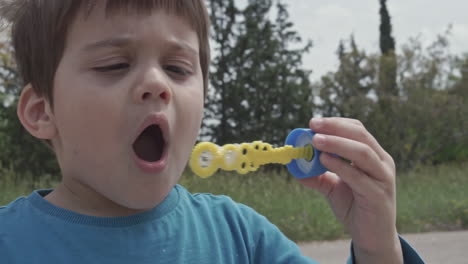 kid plays with a bubble blowing toy 60fps