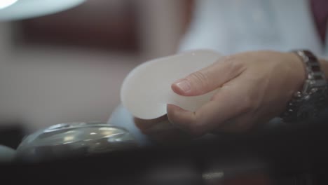 Doctor-Showing-Patients-Silicone-Breast-Prosthesis