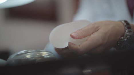 doctor showing patients silicone breast prosthesis