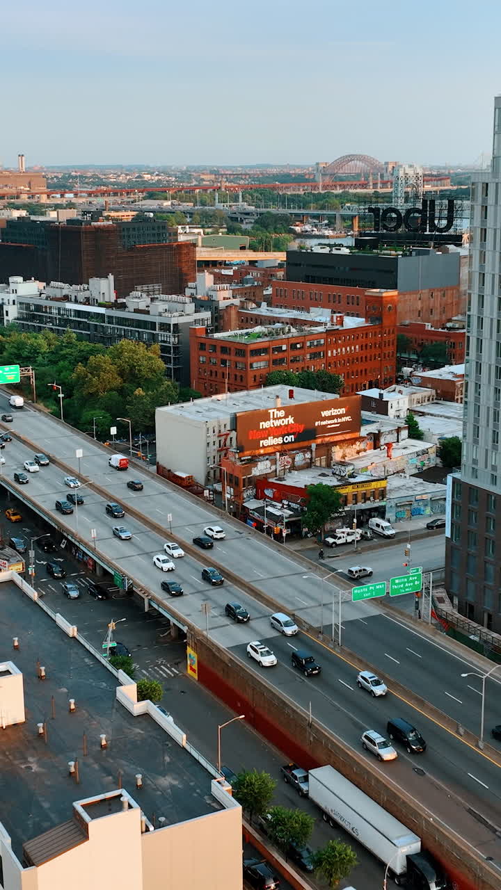 Cars move quickly by the roads and freeways of New York. Cityscape of amazing New York from aerial view. Vertical video