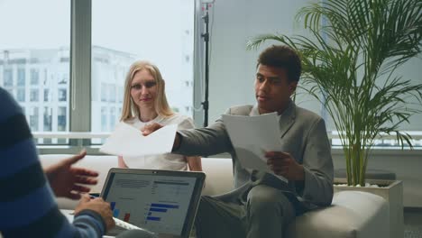 multiethnic colleagues with papers in office