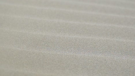 close-up of rippled sand during a sand storm in the desert