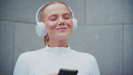 woman listening to music on headphones with smartphone