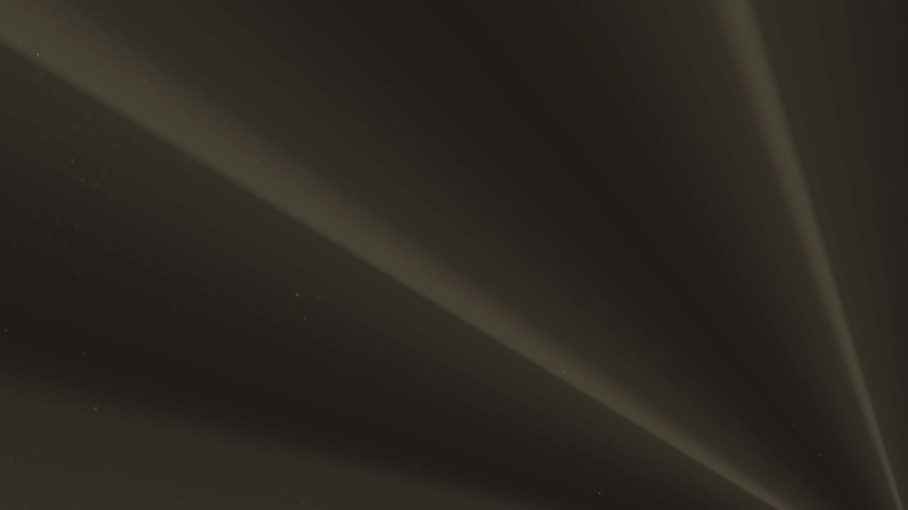 Golden particles falling against black background