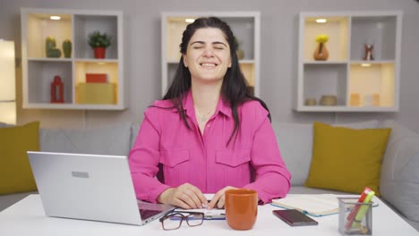 Home-office-worker-woman-winks-at-camera.