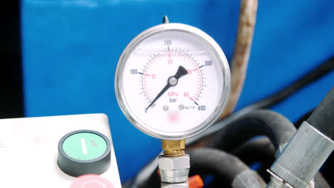 manometer with arrow on industrial equipment. pressure meters in workshop