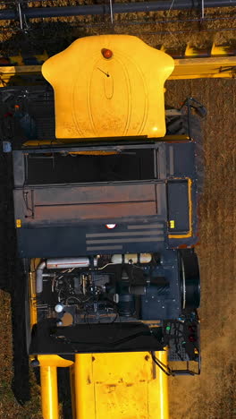 agricultural machinery theme. great modern yellow combine from above. selective focus from dron. vertical video
