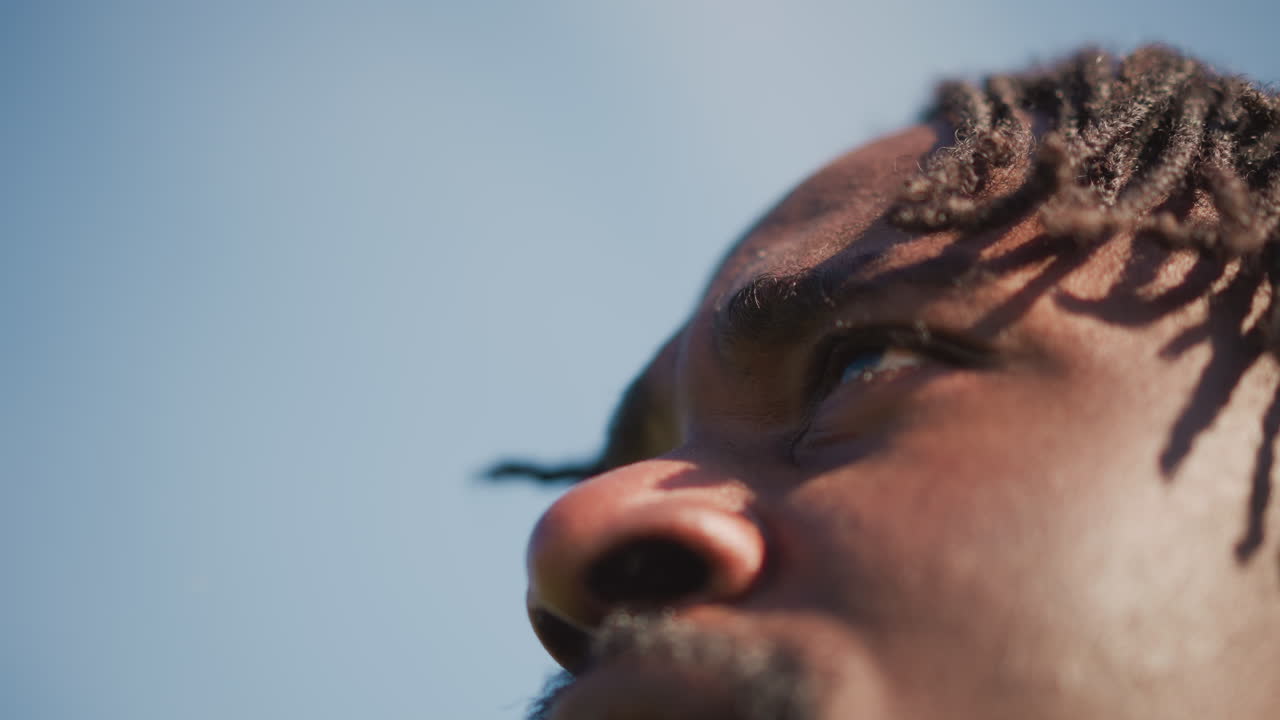 Focused Hopeful Leader, Determined Man Gazing Upward Sincerely, Sunlit Face Reflects Optimistic Visionary Outlook, Man With Focused Gaze Contemplates Future Ambitions Under Sunlight