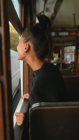 a woman on a tram looks out the window