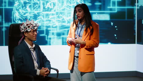 neuroscientist doing demonstration at ai convention using eeg headset