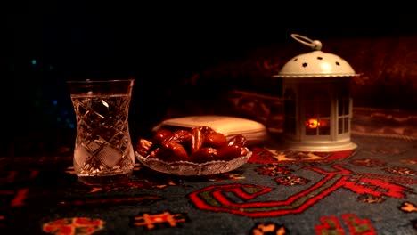 water and dates. iftar is the evening meal. slider view of decoration ramadan kareem holiday. festive greeting card, invitation for muslim holy month ramadan kareem. dark background. selective focus
