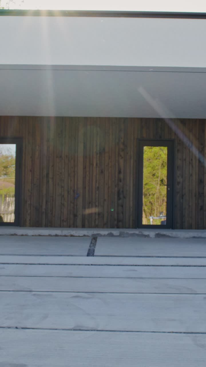 Modern House Exterior with Wooden Siding and Concrete Patio