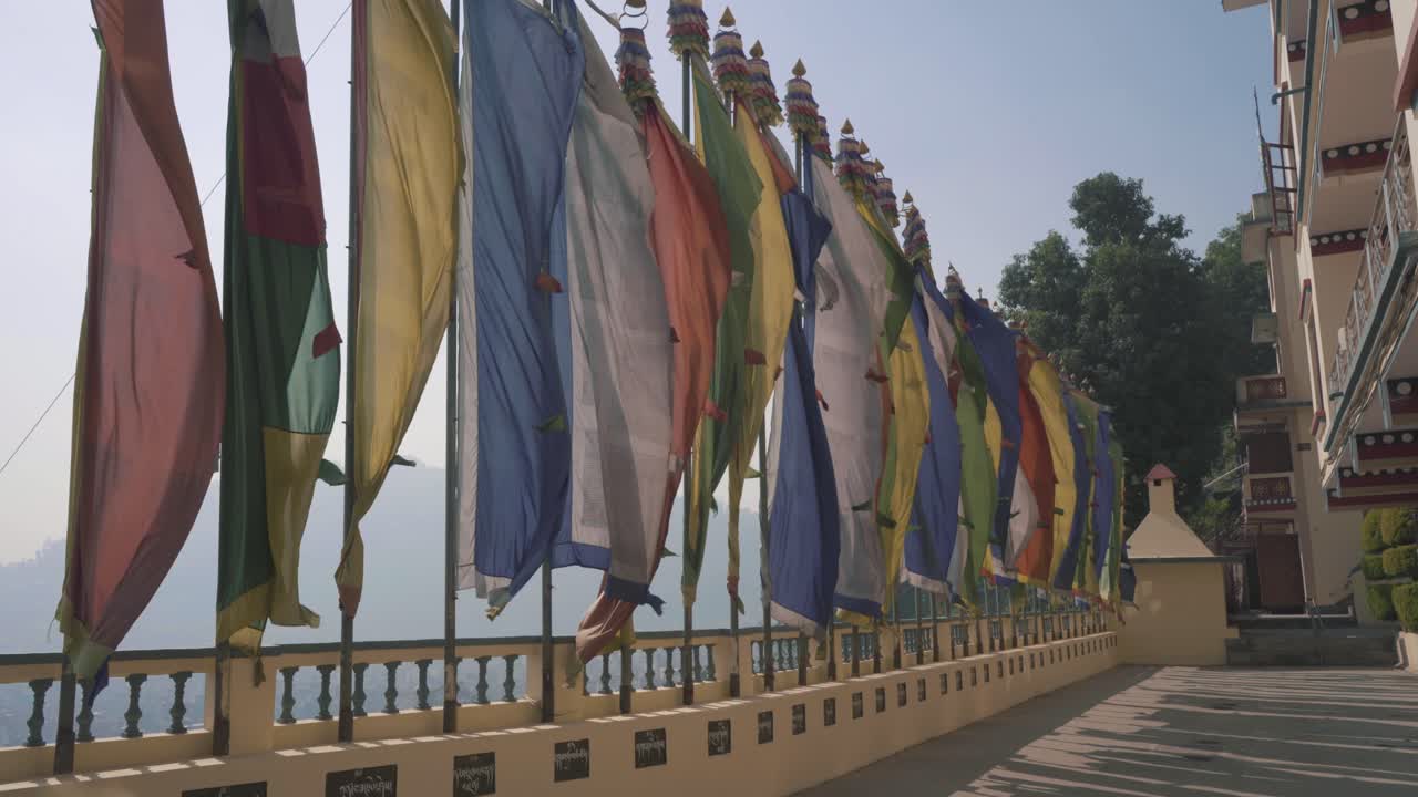 Colorful Flags Waving In The Air In Front Of Triten Norbutse Monastery In Kathmandu, Nepal On A Bright Foggy Day - Panning Shot