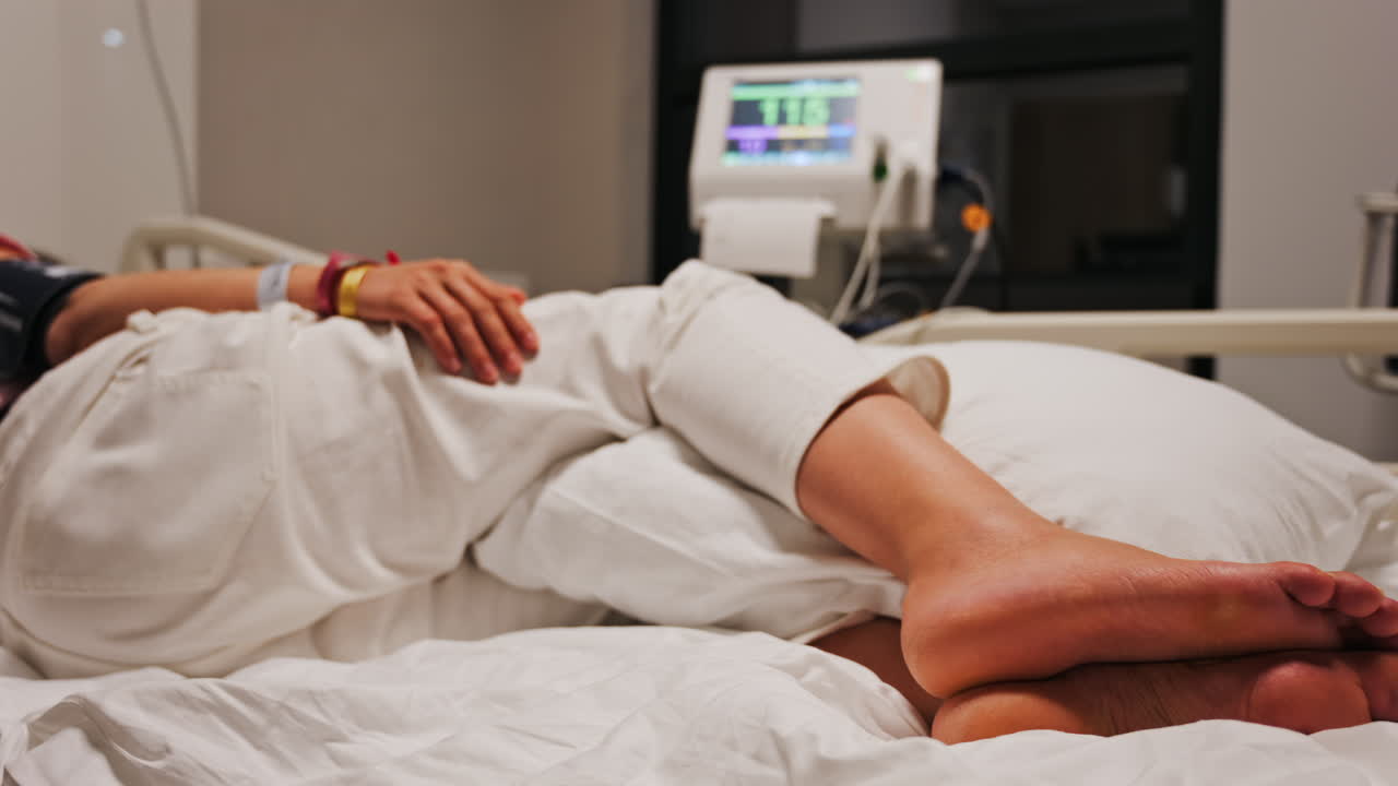 Pregnant woman lying in a hospital bed during a prenatal check-up at the doctor's office