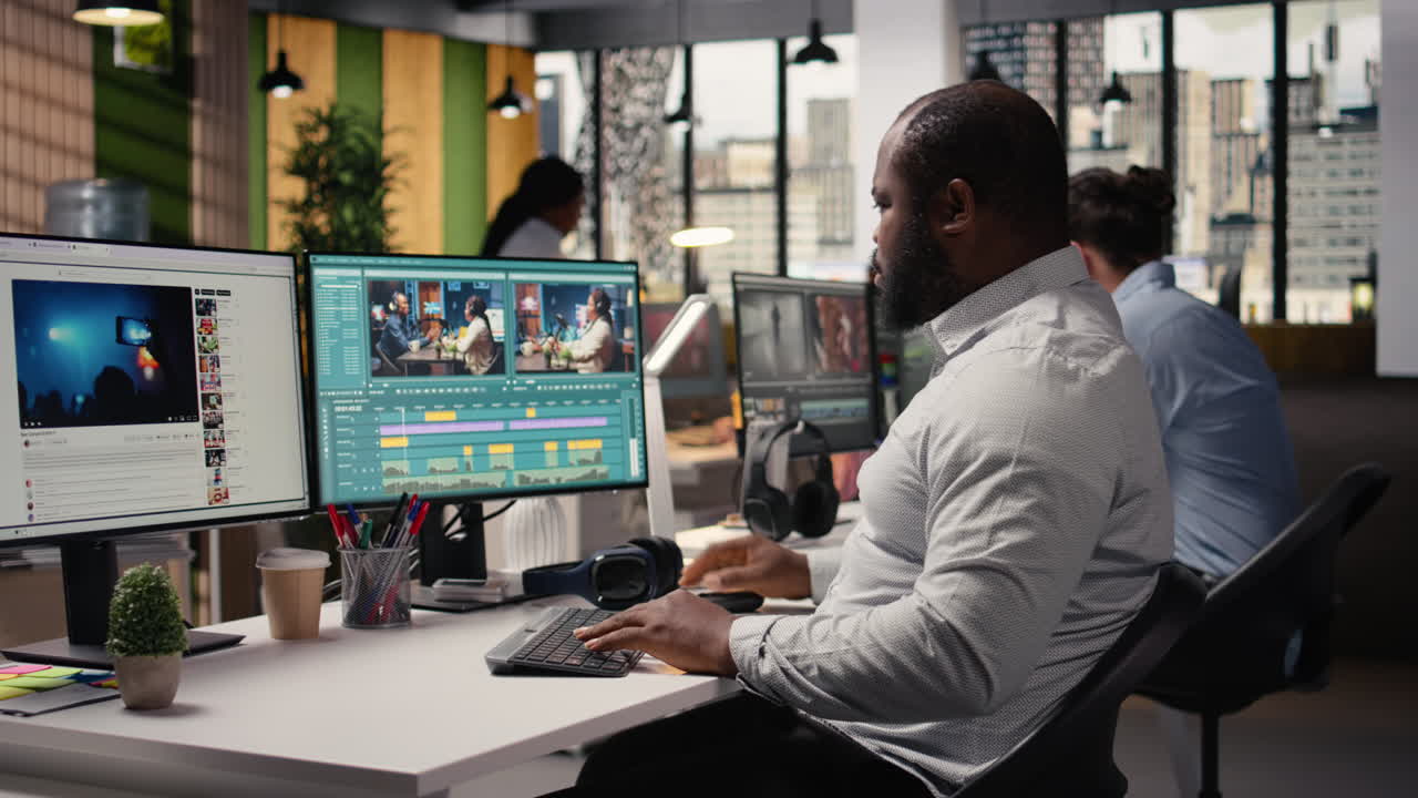 Black videographer editing raw video footage and adjusting sliders on software