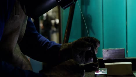 male welder working on a piece of metal