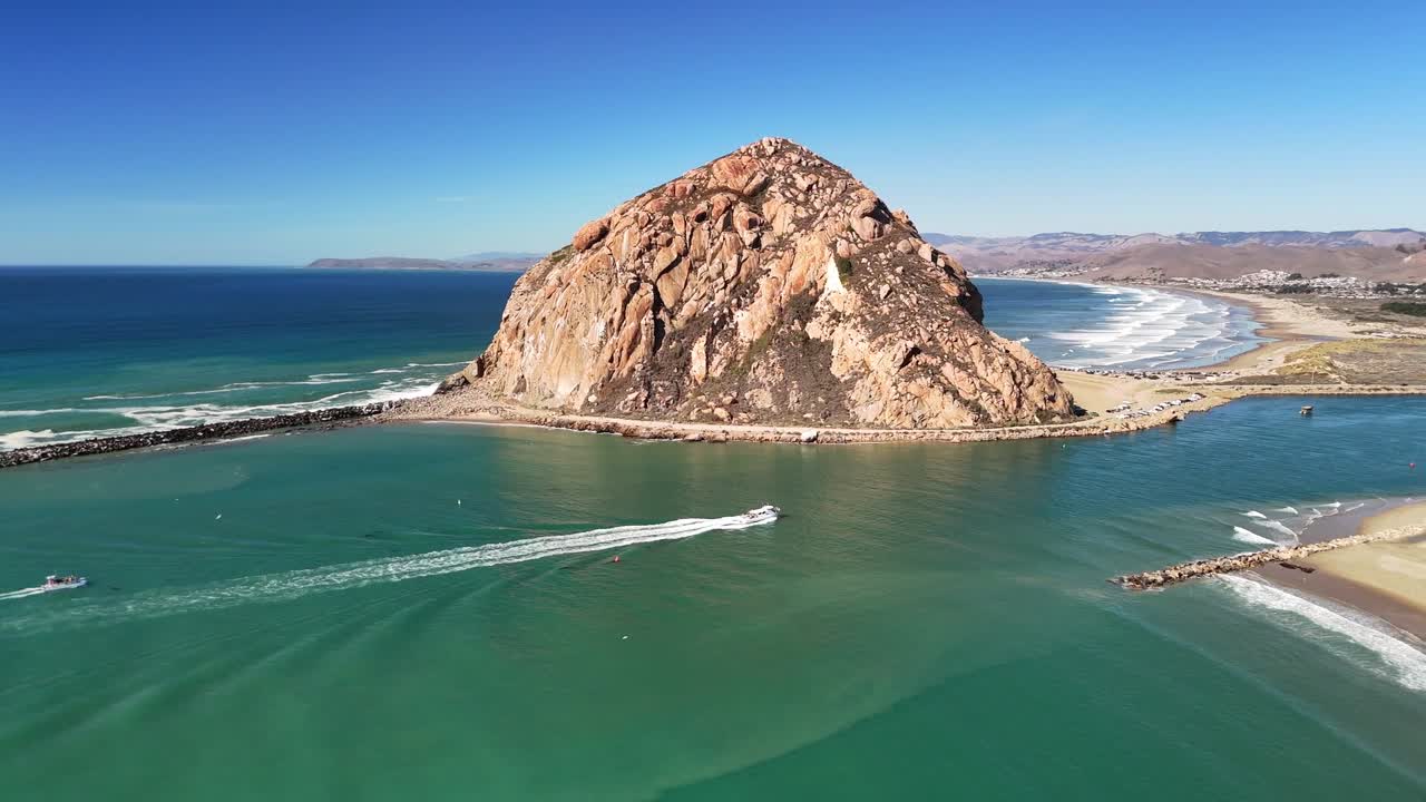 A crisp daytime shot showcasing Morro Rock surrounded by deep blue ocean and scenic coastline