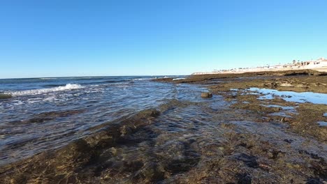 camera at water level as waves gently lap the shoreline, rocky point, puerto peñasco, mexico