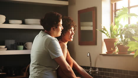 couple in kitchen looking out window