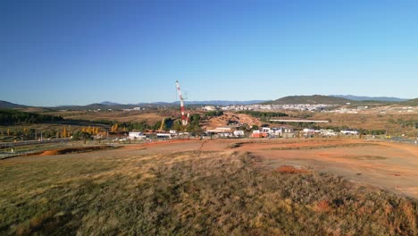 Drone captures the beginning phases of bridge construction across the Molonglo River with site prep underway.