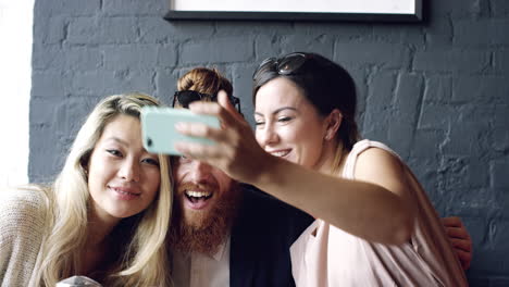 friends taking selfie photograph self portrait in cafe