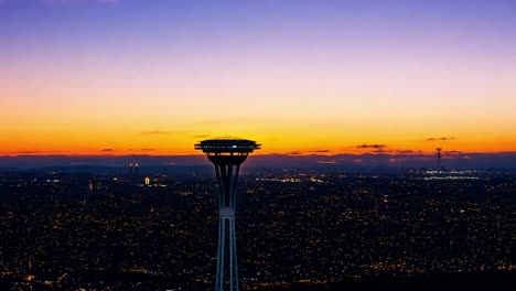 twilight casts vivid colors across seattle's skyline, highlighting the iconic space needle as night begins to fall