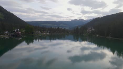 the tolblachar see in northern italy sits in a glacial valley of the dolomite mountains, the camera flies backwards