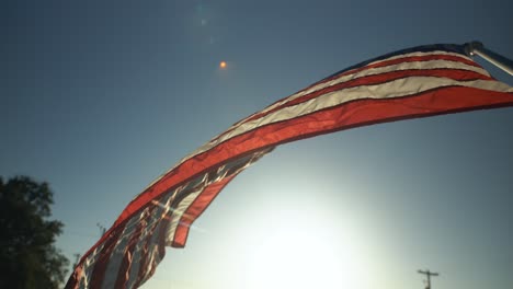 American-flag-blowing-in-dramatic-slow-motion-in-front-of-sunset