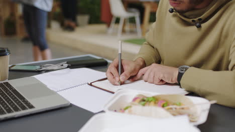 man working outdoors at a cafe