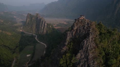 drone-shot-of-cliffs-and-road-in-Vang-Vieng,-the-adventure-capital-of-Laos