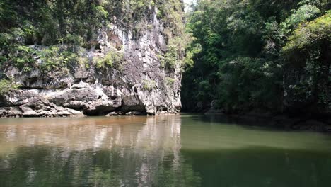 drone-flying-low-over-the-river-in-Ao-Thalane-Krabi-Thailand-with-rocks-and-a-forest-surrounding-it-on-a-sunny-day