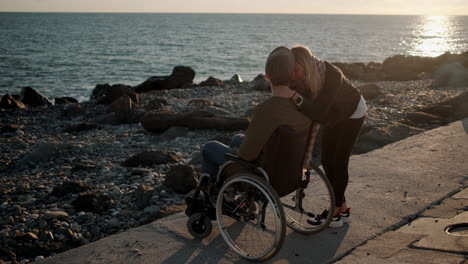 couple at the beach, sunset hugging