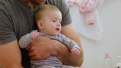 father holding his baby 4k