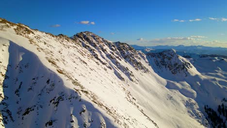 panning view of mountain landscape covered in snow. drone.