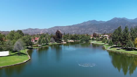 aerial drone fly down the middle of a community lake