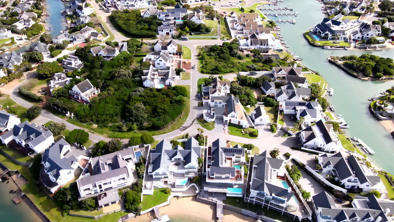 St Francis Bay white houses lining canals of marina glades, high aerial view